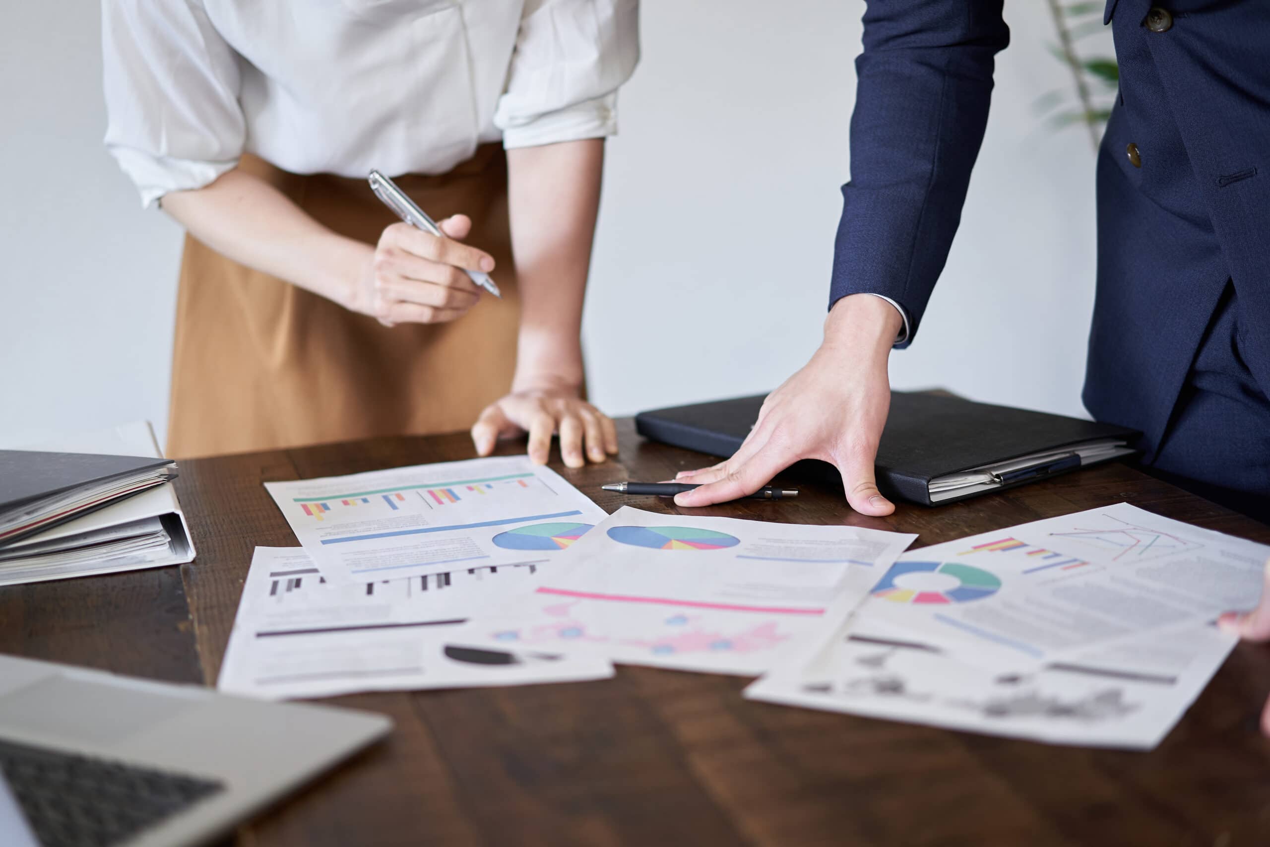 papers on desk with charts