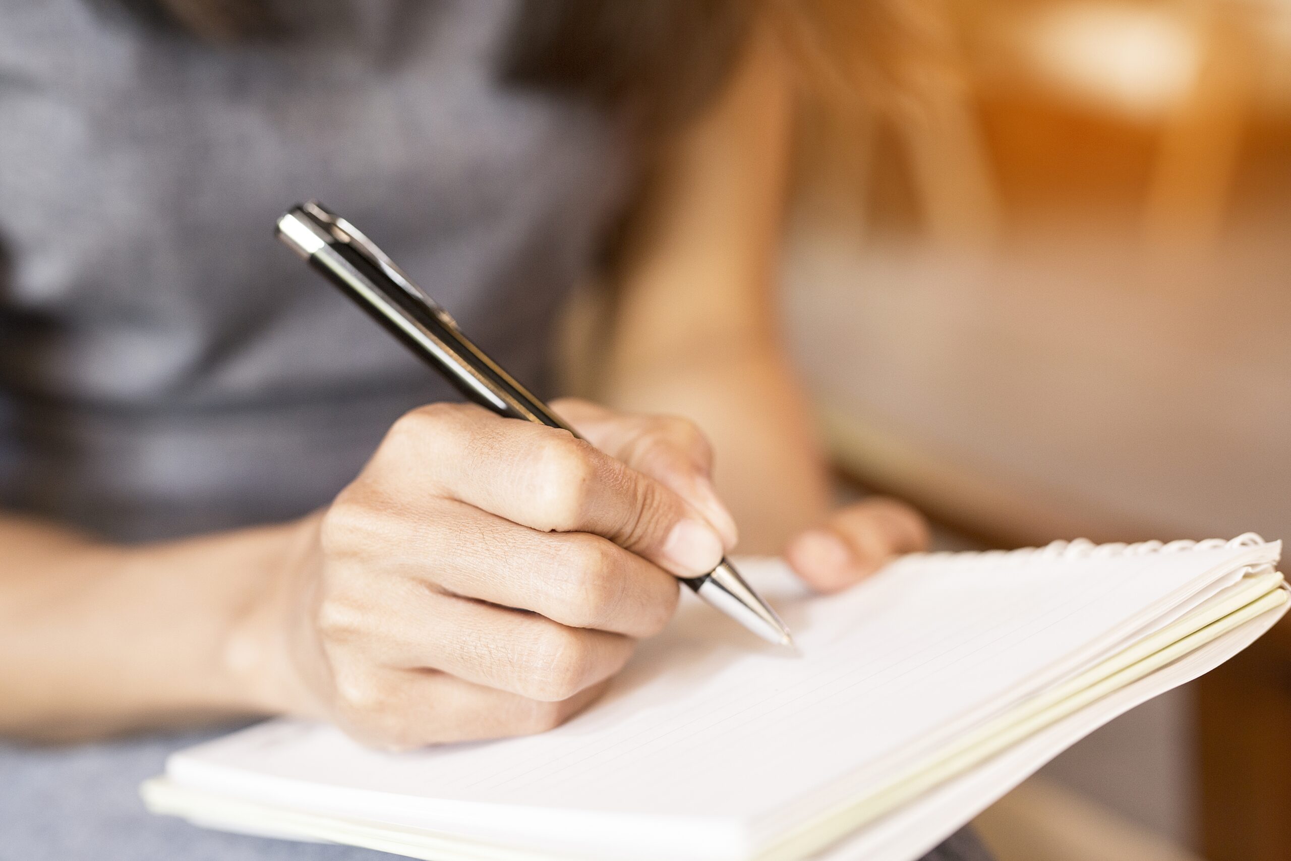 woman writing in notebook